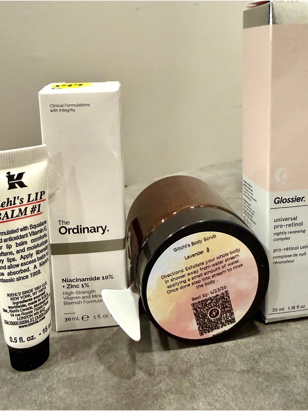 Glossier retinol, The Ordinary serum, Kiehl's lip balm, Lavender body scrub.